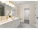 Bright bathroom with double vanity, gold fixtures, white cabinets, and a walk-in closet for plenty of storage at 2448 Sweet Birch Ct, Gastonia, NC 28054