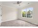 Neutral bedroom with carpet, ceiling fan, and a large window for natural light at 2448 Sweet Birch Ct, Gastonia, NC 28054