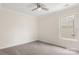 Cozy bedroom with neutral carpet, ceiling fan, and ample natural light at 2448 Sweet Birch Ct, Gastonia, NC 28054