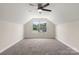 Spacious bonus room with plush carpeting, a ceiling fan, and a large window providing lots of natural light at 2448 Sweet Birch Ct, Gastonia, NC 28054