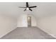 Large bonus room features plush carpets, neutral walls, a ceiling fan, and a door leading to storage space at 2448 Sweet Birch Ct, Gastonia, NC 28054