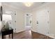 Bright foyer with hardwood floors, white trim, and a view of a bedroom at 2448 Sweet Birch Ct, Gastonia, NC 28054