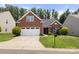 Inviting brick home featuring a well-maintained lawn and a two-car garage at 2448 Sweet Birch Ct, Gastonia, NC 28054