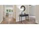 Open hallway featuring hardwood floors, a table, and views into other rooms at 2448 Sweet Birch Ct, Gastonia, NC 28054