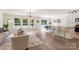 Bright, open-concept living area with hardwood floors, modern lighting, and a view to the backyard at 2448 Sweet Birch Ct, Gastonia, NC 28054