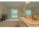 Bright, spacious bathroom with a soaking tub, double vanity, and ample natural light, creating a spa-like atmosphere at 2449 Leonhardt Rd, Cherryville, NC 28021