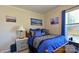 Cozy bedroom with blue bedding, nautical artwork, and a bedside table, creating a relaxing and stylish personal space at 2449 Leonhardt Rd, Cherryville, NC 28021