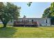 Charming single-story home with a large front yard, inviting deck, and American flag, perfect for Gathering gatherings at 2449 Leonhardt Rd, Cherryville, NC 28021