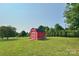 Quaint red shed providing extra storage space in a spacious yard at 2449 Leonhardt Rd, Cherryville, NC 28021