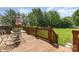 Inviting deck features comfortable outdoor seating and a peaceful view of the well-maintained backyard at 2627 Willis Dr, Harrisburg, NC 28075
