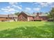 Well-manicured backyard with a deck, lush lawn, and attractive landscaping, ideal for outdoor living at 2627 Willis Dr, Harrisburg, NC 28075