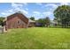 Spacious backyard offers privacy, a well-kept lawn, and ample space for outdoor activities and gardening at 2627 Willis Dr, Harrisburg, NC 28075