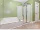 Bathroom with a soaking tub and separate glass-enclosed shower at 2627 Willis Dr, Harrisburg, NC 28075