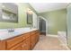 Bathroom with a dual vanity, tile flooring, and combination tub/shower at 2627 Willis Dr, Harrisburg, NC 28075