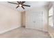 Bedroom features a ceiling fan and double closets, offering ample storage space at 2627 Willis Dr, Harrisburg, NC 28075