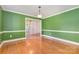 Dining room featuring hardwood floors, classic trim, and view into foyer at 2627 Willis Dr, Harrisburg, NC 28075