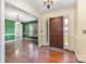 Inviting home entryway boasts hardwood floors, complemented by neutral walls and a solid wooden front door at 2627 Willis Dr, Harrisburg, NC 28075