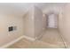 Upstairs hallway features carpeted floor and a door at the end of the hall at 2627 Willis Dr, Harrisburg, NC 28075