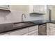 Kitchen counter featuring a stainless steel sink and dark countertops at 2627 Willis Dr, Harrisburg, NC 28075