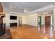 Spacious living room with hardwood floors, a ceiling fan, and a fireplace at 2627 Willis Dr, Harrisburg, NC 28075