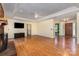 Spacious living room with hardwood floors, a ceiling fan, and a fireplace at 2627 Willis Dr, Harrisburg, NC 28075
