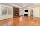 Bright living room features hardwood floors, fireplace, and ceiling fan for added comfort at 2627 Willis Dr, Harrisburg, NC 28075