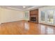 Bright living room with hardwood floors, a brick fireplace, and French doors leading to the backyard at 2627 Willis Dr, Harrisburg, NC 28075