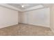 Neutral main bedroom with tray ceiling and neutral carpeting at 2627 Willis Dr, Harrisburg, NC 28075