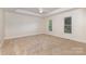 Spacious main bedroom with plush carpeting, tray ceilings, and natural light at 2627 Willis Dr, Harrisburg, NC 28075