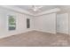Bright and airy main bedroom with recessed ceiling and neutral carpeting at 2627 Willis Dr, Harrisburg, NC 28075
