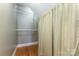 Walk-in closet with wooden floors, wire shelving and a decorative curtain at 2627 Willis Dr, Harrisburg, NC 28075