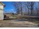 Large backyard featuring a fenced in yard, mature trees, and a concrete patio at 2712 Thornburg Ct, Monroe, NC 28110