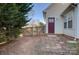 Backyard featuring a wooden fence, a burgundy door, and a brick pathway at 2712 Thornburg Ct, Monroe, NC 28110