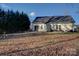 Backyard featuring mature trees and green grass at 2712 Thornburg Ct, Monroe, NC 28110