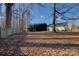 Expansive backyard features mature trees, a sturdy wooden fence, and ample space for outdoor activities at 2712 Thornburg Ct, Monroe, NC 28110