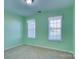 Cozy bedroom featuring two windows with curtains and neutral carpet at 2712 Thornburg Ct, Monroe, NC 28110
