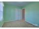 Mint green bedroom featuring carpeting, closet, and doorway at 2712 Thornburg Ct, Monroe, NC 28110