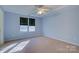 Bright blue bedroom with carpeting, fan, recessed ceiling and two bright windows at 2712 Thornburg Ct, Monroe, NC 28110