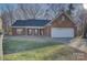 Charming brick home with a well-manicured lawn and attached two-car garage at 2712 Thornburg Ct, Monroe, NC 28110