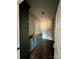 Bathroom with light blue cabinets, dark wood floors and a white door at 3000 Paul Payne Store Rd, Taylorsville, NC 28681