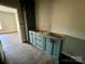 Bathroom with light blue cabinets, dark wood floors, and an entrance to another room at 3000 Paul Payne Store Rd, Taylorsville, NC 28681