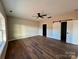 Spacious bedroom with a ceiling fan, wood-look flooring, and natural light from a window at 3000 Paul Payne Store Rd, Taylorsville, NC 28681
