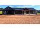 New construction featuring a dark exterior, metal roof, exposed timber accents, and attached garage at 3000 Paul Payne Store Rd, Taylorsville, NC 28681