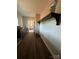 Hallway with dark wood floors, shelving, and cabinets leading into the kitchen at 3000 Paul Payne Store Rd, Taylorsville, NC 28681