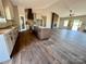 Spacious kitchen featuring a center island, fireplace, and ample natural light through large windows at 3000 Paul Payne Store Rd, Taylorsville, NC 28681