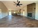Open concept living space featuring wood flooring, fireplace with stone accent wall, and open kitchen at 3000 Paul Payne Store Rd, Taylorsville, NC 28681