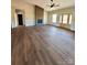 An open-concept living room with fireplace and stone accent wall, and a double glass-paneled front door at 3000 Paul Payne Store Rd, Taylorsville, NC 28681