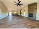 Open concept living space featuring wood flooring, fireplace with stone accent wall, and open kitchen at 3000 Paul Payne Store Rd, Taylorsville, NC 28681