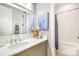 Bright bathroom featuring a vanity with granite countertop and a shower-tub combo at 3237 Sunset Dr, Charlotte, NC 28209