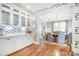 Bright dining room with white cabinets, open to the dining area, showcasing stylish geometric wallpaper at 3237 Sunset Dr, Charlotte, NC 28209